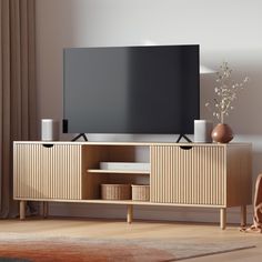 a flat screen tv sitting on top of a wooden entertainment center