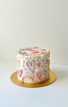 a cake with hearts on it sitting on a plate