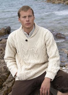 "Aran Dublin Shawl Collar Natural Sweater Certificate of Authenticity COLOR Natural Men's Irish wool sweaters made from 100% Soft Merino Wool. This mans shawl collar Dublin Shawl Collar Black Aran Sweater is knit using traditional knitting patterns from Ireland. The \"V\" neck shawl collar is the main feature of this Irish sweater. It is completed with the use of an old style button closure. The diamond knitting pattern along the body is said to represent wealth and success. This men's Irish woo Diamond Knitting Pattern, Irish Wool Sweaters, Irish Knitwear, Irish Sweater, Irish Style, Shawl Collar Sweater, Herringbone Stitch, Aran Sweater, Fisherman Sweater