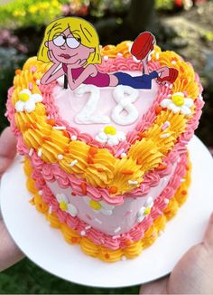 a heart shaped cake with a cartoon character on it's top and the number twenty