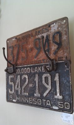 two old license plates are hanging on the wall