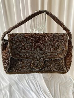 "Gorgeous chocolate brown evening bag, heavily beaded with bronze and light gray blue colored beads! No label, except \"made in france\". Snap closure! Fabric looks like silk!  I suspect this to be from the 1920's ~ measurements: 7 1/4 x 2 1/4\" base 5 1/2\" height 8\" high with strap" Vintage Brown Evening Bag For Party, Brown Embellished Evening Bag, Evening Brown Beaded Shoulder Bag, Vintage Brown Shoulder Bag For Party, Beaded Handbag, Clutch Handbag, Made In, Chocolate Brown, Light Gray