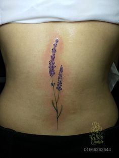 a woman's stomach with purple flowers on it