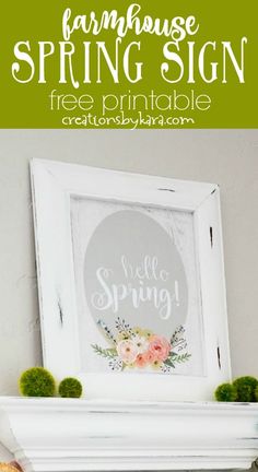 a white fireplace mantle with moss and flowers on it