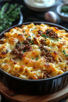 a casserole dish with meat and cheese in a pan on a wooden board