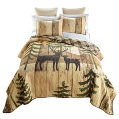 a bed with two moose and pine trees on it