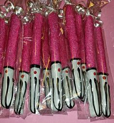 pink and white candles are wrapped in plastic