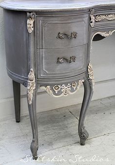 an old dresser painted gray with white trim