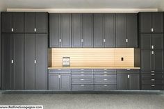 an empty garage with lots of cabinets and drawers