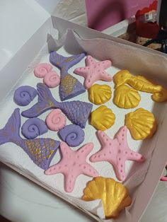 a box filled with decorated cookies sitting on top of a table