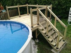 an above ground swimming pool with steps leading up to the deck and above ground hot tub