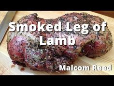 smoked leg of lamb on a cutting board with the words smoked leg of lamb