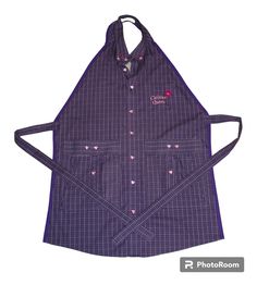 a purple apron with hearts on it