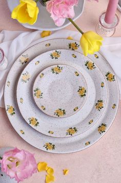 three plates with yellow and pink flowers on them