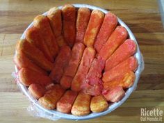 a bowl filled with sliced up carrots on top of a wooden table