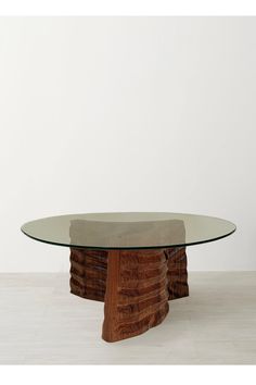 an oval glass table with wooden base