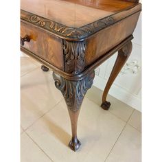 an ornate wooden desk with drawers on it