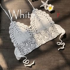 a crocheted white doily with flowers on it and the words whit