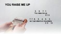 a person holding a comb in their hand with the words you raise me up above it