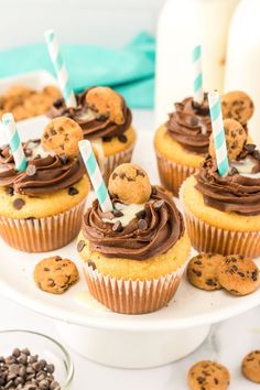 cupcakes with chocolate chip cookies and marshmallows are on a plate