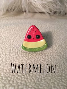 a watermelon pin sitting on top of a bed