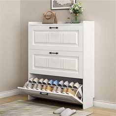 a white shoe rack with shoes underneath it