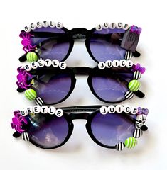 "BEETLEJUICE BEETLEJUICE BEETLEJUICE SUNNIES!! These are so adorable-- Each pair is handcrafted by me. Using various beads, Charms, Rhinestones, and fun details!  🪲  *3 options available-- (see pictured) Choose your style:  1. Graveyard  2. Skull 3. glitter bow  * Anti-Glare * UV Protection (UVA & UVB) * Durable and shatterproof  * They open and close smoothly  * Each item is made to order and will be ready to ship in 5-7 business days! If you need your order sooner. Please check out my \"RUSH ORDER OPTION\".  https://www.etsy.com/EyeCandyandFluff/listing/1286351273/rush-my-order-please *SHOP DISCLAIMER/WAIVER!  * Do NOT let your child put the sunglasses in their mouth as beads can become detached.    Always monitor and supervise while children are wearing these. The shop assumes no respo Beetlejuice Jewelry Diy, Halloween Sunglasses, Halloween Glasses, Diy Sunglasses, Beaded Sunglasses, Teacher Appreciation Gifts Diy, Festival Sunglasses, Personalized Sunglasses, Beetlejuice Beetlejuice