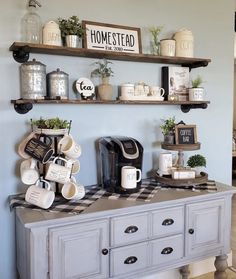 some shelves with coffee cups and mugs on them in a dining room area that is painted blue