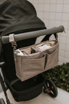 a baby stroller with an open diaper bag in it's back pocket