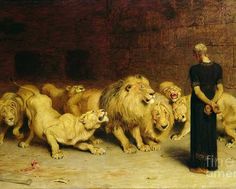 a woman standing in front of a group of lions