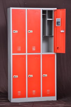 an orange and grey metal locker with several doors on the front, one door open