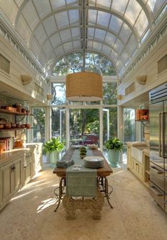 an image of a dining room and kitchen with sun coming through the windows on the ceiling