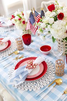 the table is set with red, white and blue place settings for an american celebration