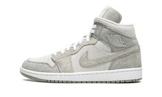 The Women’s Air Jordan 1 Mid SE “Particle Grey Suede” is a women’s-exclusive colorway of the popular lifestyle shoe in a colorway that features a unique combination of materials.  The “Particle Grey Suede” Jordan 1 Mid features hairy suede panels and Swoosh branding designed in Particle Grey and College Grey.  The overlays are contrasted by a light grey suede base.  A metal “Wings” logo is found on the collar and grey Jumpman and “Air” branding appear on the tongue tag.  Ideal for cooler tempera Particle Grey Jordan 1, Jordans Gray, Womens Air Jordan 1, Womens Air Jordan, Air Jordans Women, Nike Sacai, Air Jordan 1 Mid Se, Womens Air Jordans, Wings Logo