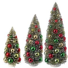 three small christmas trees with red, green and gold ornaments