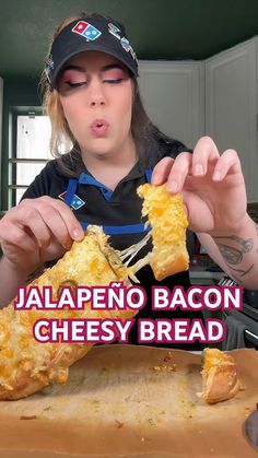 a woman holding up a piece of cheesey bread in front of her face with the caption jalapeno bacon cheesy bread