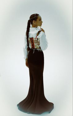 a woman with braids in a long dress