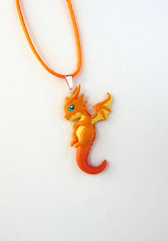 "Polymer Clay Baby Dragon Necklace - Small Dragon Pendant - Chibi Dragon Necklace - Dragon Jewelry - Dragon Friendship Necklace - Polymer Clay Jewelry Super cute hand sculpted Baby Dragon Pendants. Comes with a silver stainless steel necklace or Satin Cord. Real sterling silver necklace possible on request. Buy two and have a great Friendship Necklace Set! Dragon Fans will love this piece of art! Entirely handmade with Polymer Clay by me. *CUSTOM ORDER! The actual product could look slightly dif Httyd Jewelry, Video Game Jewelry, Chibi Dragon, Small Dragon, Necklace Dragon, Tiny Dragon, Necklace Polymer Clay, Cute Dragon, Book Necklace