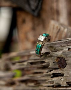 a close up of a ring on a piece of wood