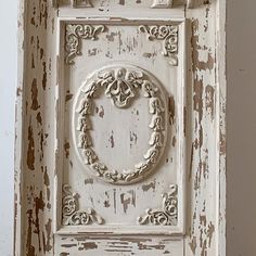 an old white door with a decorative frame