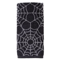 a black and white towel with spider web pattern on the front, against a white background