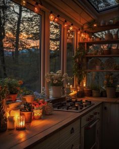 the kitchen is lit up with candles and potted plants on the windowsills