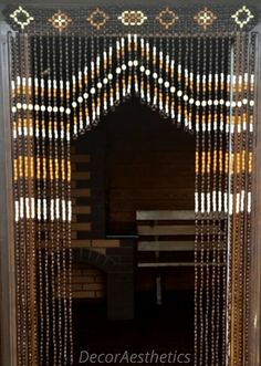 a door with beads hanging from it's sides and a bench in the middle