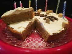 a cake that has been cut in half with candles on it and is sitting on a red plate