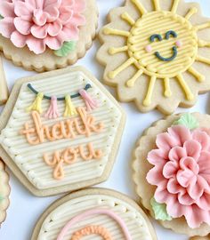 decorated cookies with the words thank you written in frosting and flowers on each cookie