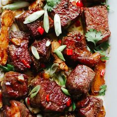 meat and vegetables on a plate ready to be cooked in the oven or served for dinner