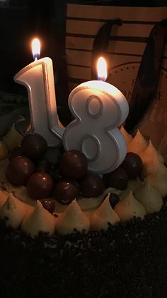 the birthday cake is decorated with chocolate and lit candles in the shape of an eight