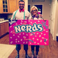 two people holding up a sign that says nerds