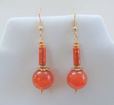 Carnelian Drops - 15mm Genuine Gemstone Carnelian antique beads, with porcelain Asian beads, new gold plated beads and earwires I love pairing carnelian with gold, and matching these tiny Asian painted porcelain, was such luck! Solid stone bead, but lightweight and lovely to wear. Elegant Carnelian Dangle Earrings, Orange Jade Jewelry Gift, Handmade Adjustable Carnelian Earrings, Orange Carnelian Round Bead Jewelry, Carnelian Gemstone Dangle Earrings, Handmade Carnelian Orange Earrings, Round Orange Carnelian Earrings, Orange Carnelian Earrings, Orange Carnelian Round Earrings