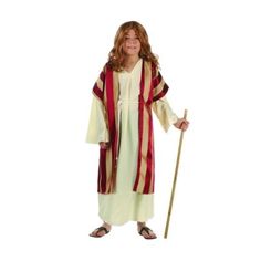 a child dressed as jesus holding a stick and wearing a red and white striped robe